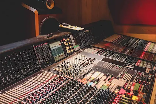 Engineer evaluating analog vs digital mastering results for streaming and real-world playback systems